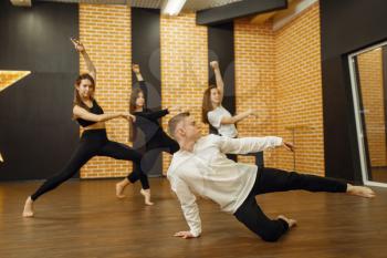 Contemporary dance performers posing in studio. Female and male dancers training in class, modern grace dancing, stretching exercise, acrobats