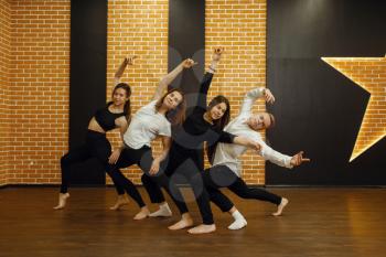 Contemporary dance performers in studio, snapshot in action. Female and male dancers training in class, modern grace dancing, stretching exercise, aerobic