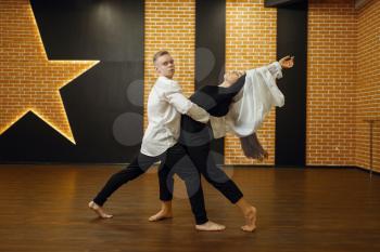 Contemporary dance performers, couple training in studio. Male and female dancers on workout in class, modern dancing, stretching exercise