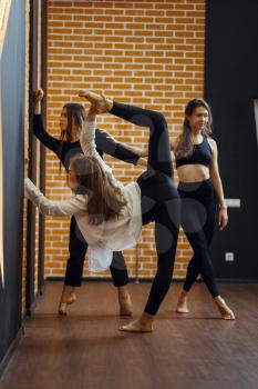 Contemporary dance performers, women on workout in studio. Dancers training in class, modern ballet, elegance dancing, stretching exercise