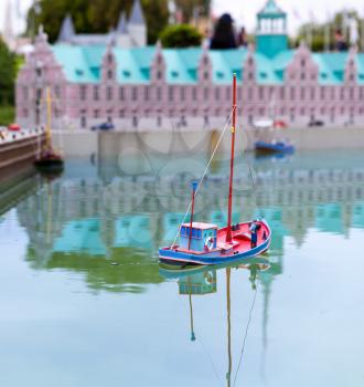 Fishman on fishing boat, miniature scene outdoor, europe. Mini figures with high detaling of objects, realistically diorama