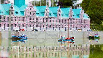 Fishing boats at the pier, miniature scene outdoor, europe. Mini figures with high detaling of objects, realistically diorama