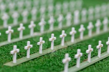Cemetery, grave crosses and green grass, miniature scene outdoor, europe. Mini figures with high detaling of objects, realistically diorama, toy model
