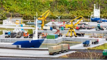 Cargo ships, crane and trucks in port, miniature scene outdoor, europe. Mini figures with high detaling of objects, realistically diorama