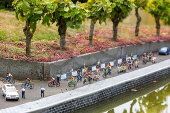 Bike marathon on city street, miniature scene outdoor, europe. Mini figures with high detaling of objects, realistically diorama, toy model