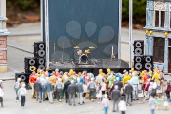 People at the music scene, concert on city street, miniature outdoor, europe. Mini figures with high detaling of objects, realistically diorama, toy model
