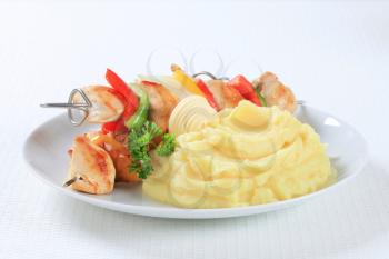 Chicken skewers served with mashed potato