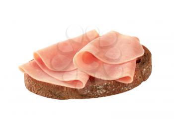 Thin slices of ham on brown bread