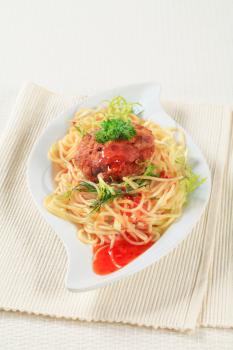 Meat patty with spaghetti and spicy sauce