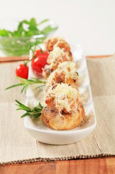 Mushrooms stuffed with minced meat sprinkled with grated cheese