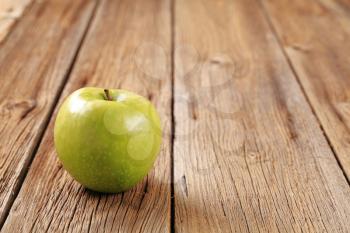 Granny Smith green apple on wooden table