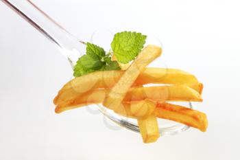 French fries on a plastic spoon - detail