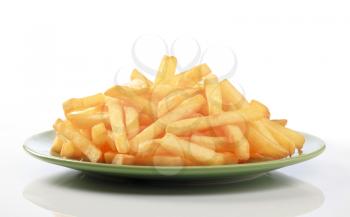 Heap of French fries on a green plate
