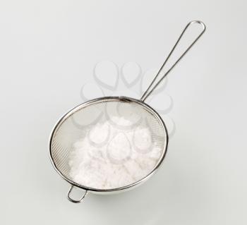Powdered sugar in a metal sieve - studio