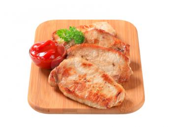 Pan-fried slices of pork with tomato sauce