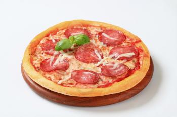 Fresh baked pizza salami on cutting board