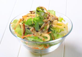 Bowl of green salad with cheese and balsamic vinegar