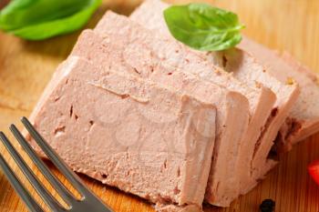 Sliced liver pate on cutting board