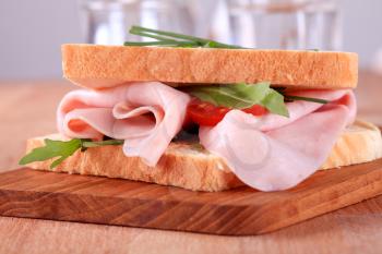 Ham sandwich with salad greens and chives