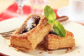 Chocolate filled puff pastry tart shell sprinkled with sesame seeds
