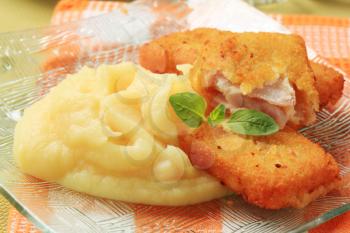 Fried breaded fish fillets served with mashed potato