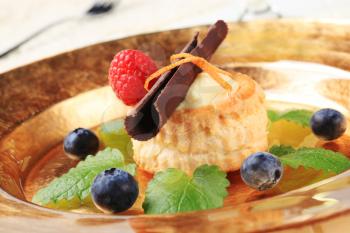 Cream filled vol-au-vent garnished with chocolate curl and fruit