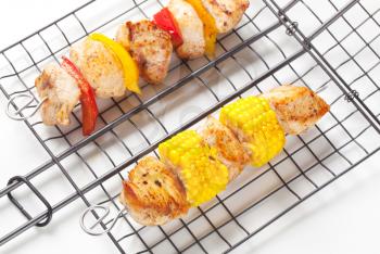 Chicken skewers on a grilling grid
