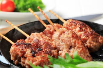 Minced meat kebabs on wooden sticks