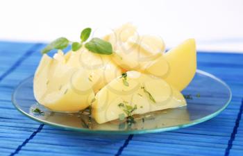 Portion of boiled potato wedges on a plate