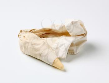 Pastry bag with plastic tip filled with cream