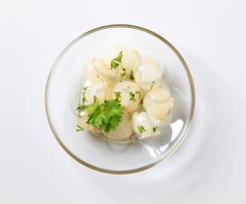Accompaniment - Pickled pearl onions on a plate