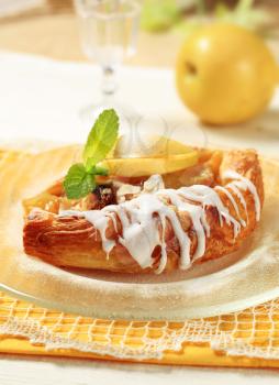Danish pastry with apple filling and sugar icing 