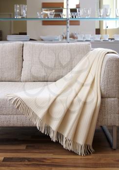 Cream throw draped over a settee
