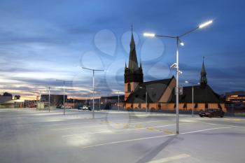 Empty car park illuminated by street lights