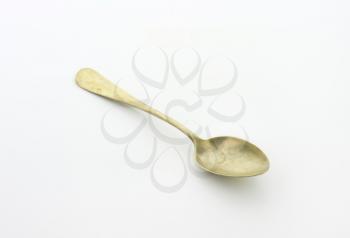Old silver spoon covered with tarnish