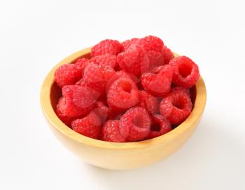 Fresh raspberries in a wooden bowl