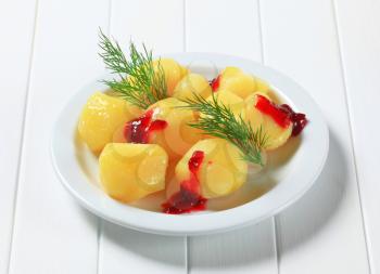 Cooked potatoes with dill and cranberry sauce