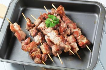 Pork skewers in a baking tin