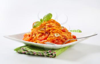 Thin spaetzle in garlic tomato sauce