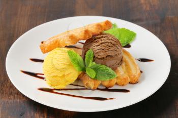 Two scoops of ice cream with puff pastry biscuits