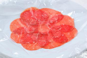 Thinly sliced raw beef meat