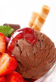 Chocolate ice cream with strawberry sauce