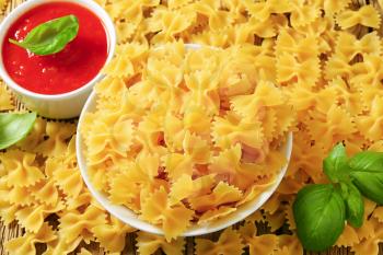 Uncooked bow tie pasta and tomato puree