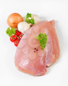 Raw turkey breast and vegetables 
