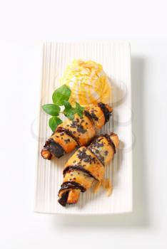 Chocolate-filled croissants and scoop of ice cream on plate