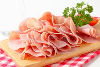 Thinly sliced ham on cutting board