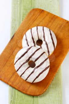 Ring donuts with vanilla and chocolate glaze