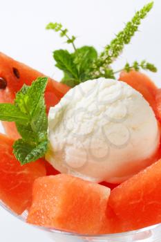 Scoop of white ice cream with diced watermelon