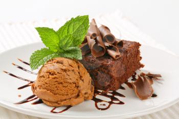 Brownie with chocolate curls and ice cream