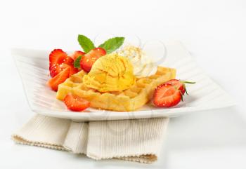 Belgian waffle with fresh strawberries and ice cream